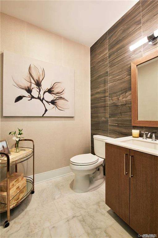 100 Garvies Point Road, Unit 1202 Glen Cove, NY 11542 - Photo 7 of 14 Bathroom featuring vanity and tile walls
