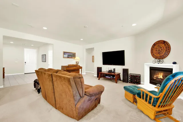 a kitchen with stainless steel appliances kitchen island granite countertop a table chairs and a refrigerator