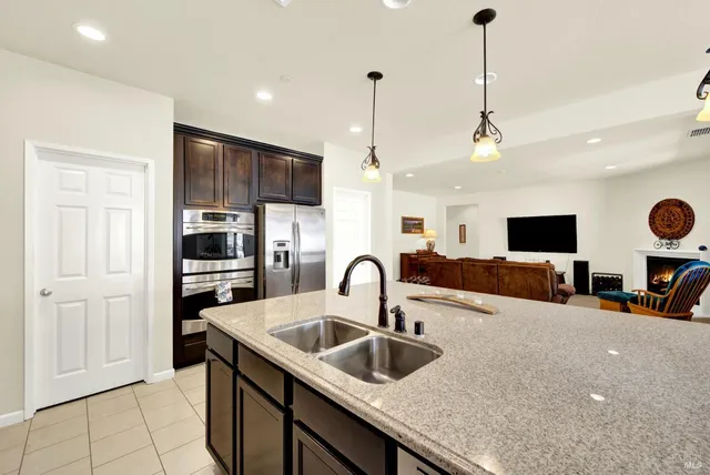 a kitchen with a sink a counter and chairs