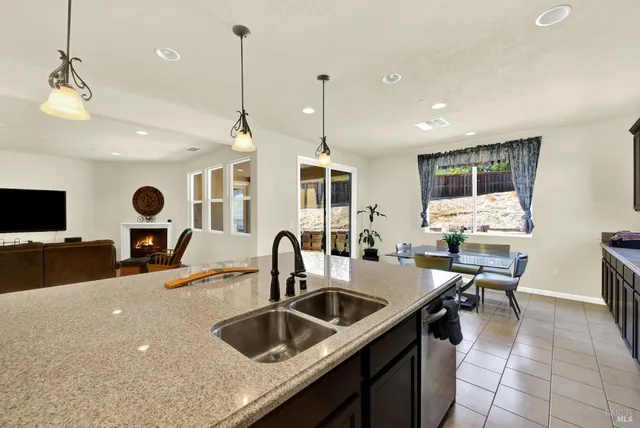a kitchen with stainless steel appliances a sink stove and microwave