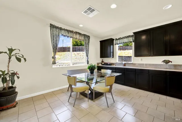 a living room with stainless steel appliances kitchen island granite countertop a couch and a view of living room
