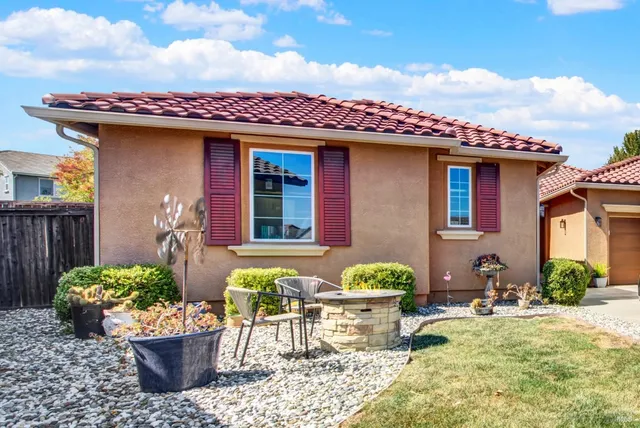 a front view of a house with outdoor seating