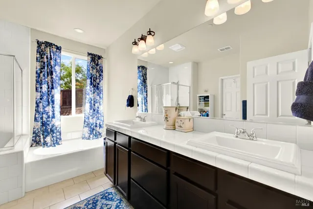 a view of a hallway with bathroom and shower