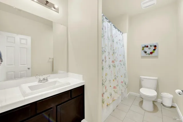 a bathroom with a sink mirror and a toilet