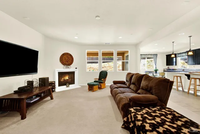 a living room with furniture fireplace and a flat screen tv
