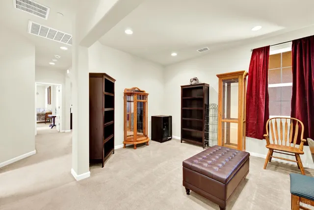 a view of a room with chairs and windows