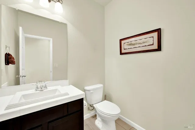 a view of a house with a patio and a yard