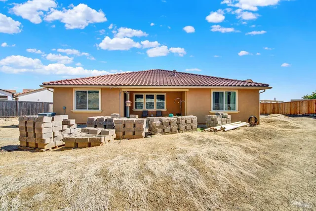 a view of a house with wooden fence