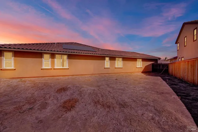 a front view of a house with a chairs and table