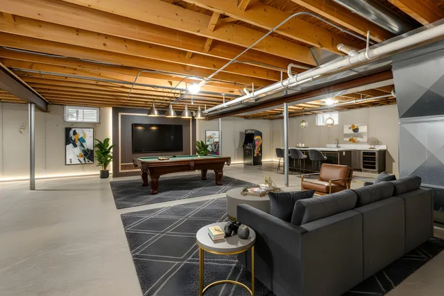 a kitchen with stainless steel appliances granite countertop a refrigerator a stove and a sink with wooden floor