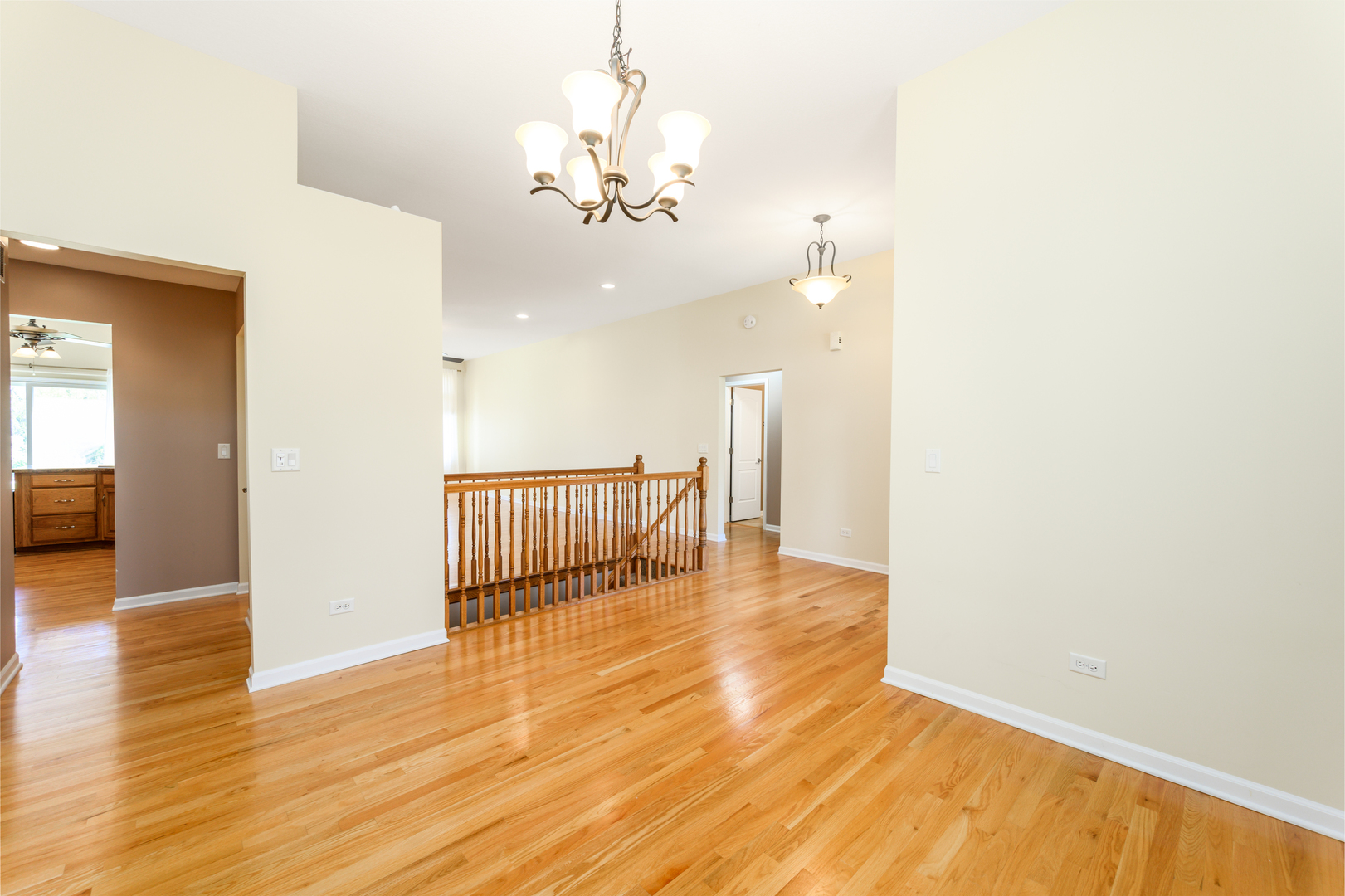 592 South Walnut Street Manteno, IL 60950 - Photo 17 of 37 a view of a room with wooden floor staircase and kitchen view