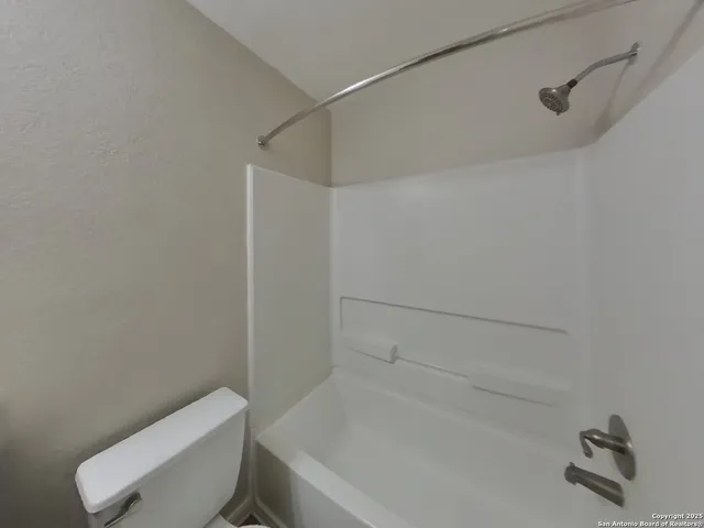 a bathroom with a toilet and a bathtub