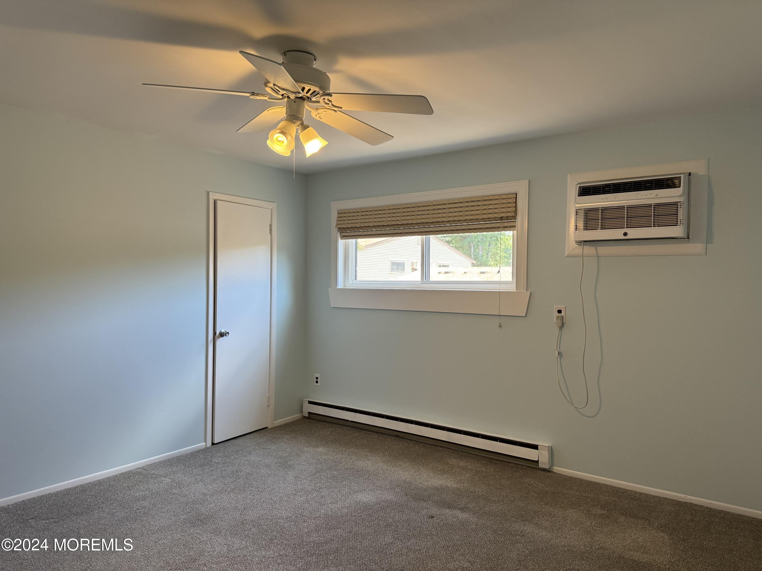 95 Lexington Court Red Bank, NJ 07701 - Photo 13 of 26 an empty room with windows and fan