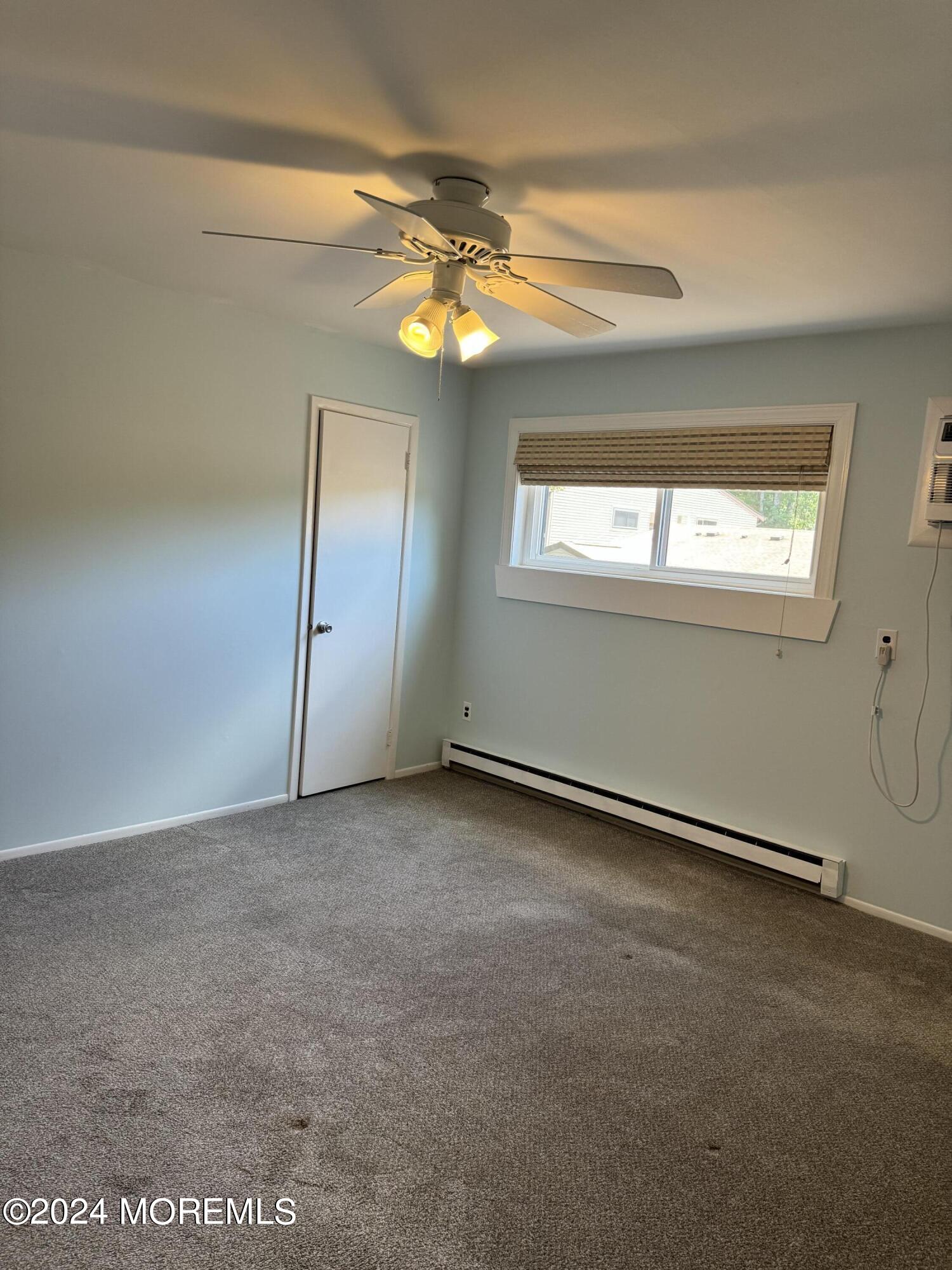 95 Lexington Court Red Bank, NJ 07701 - Photo 14 of 26 an empty room with windows and chandelier fan