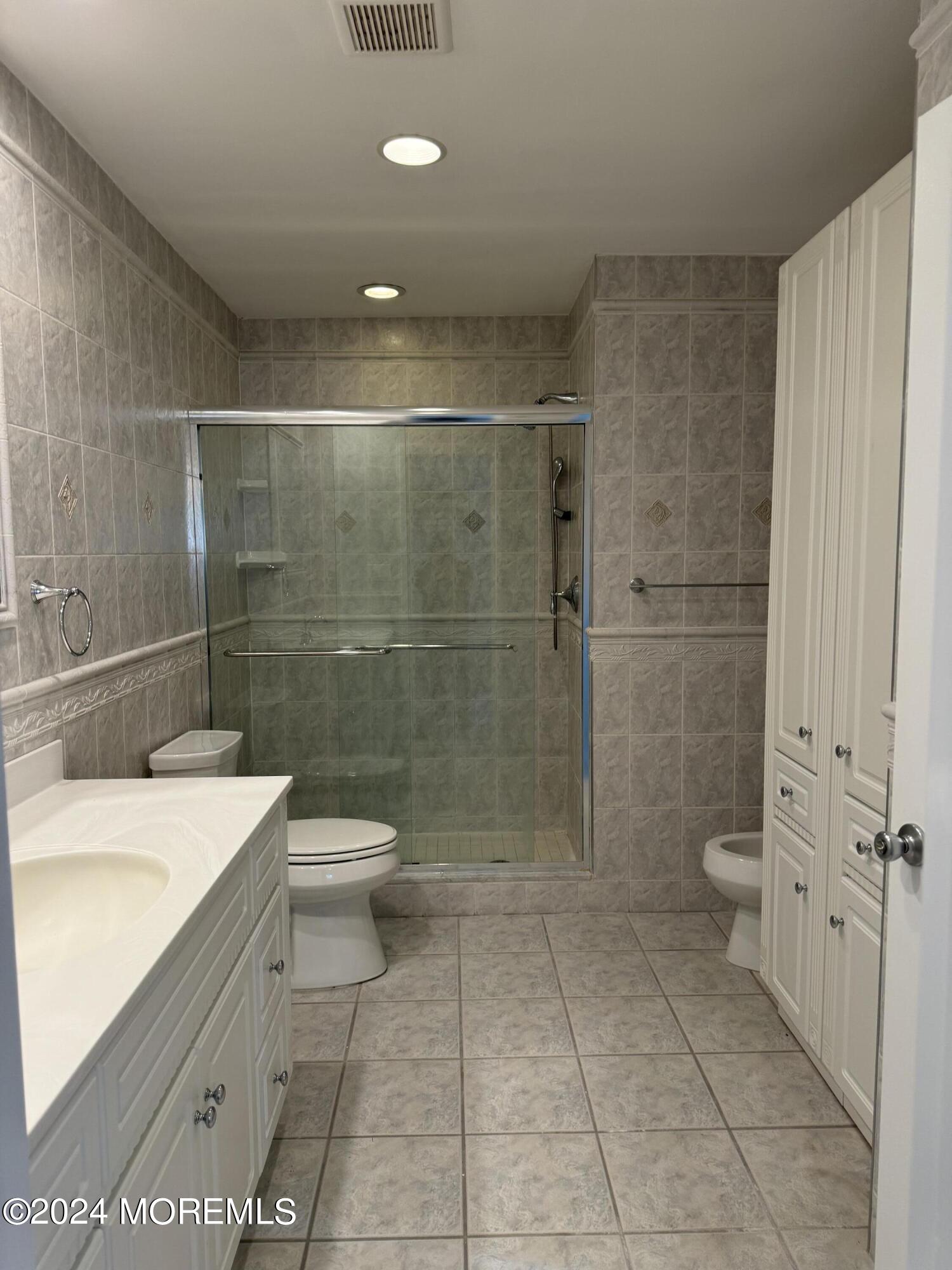 95 Lexington Court Red Bank, NJ 07701 - Photo 19 of 26 a bathroom with a toilet a sink and shower
