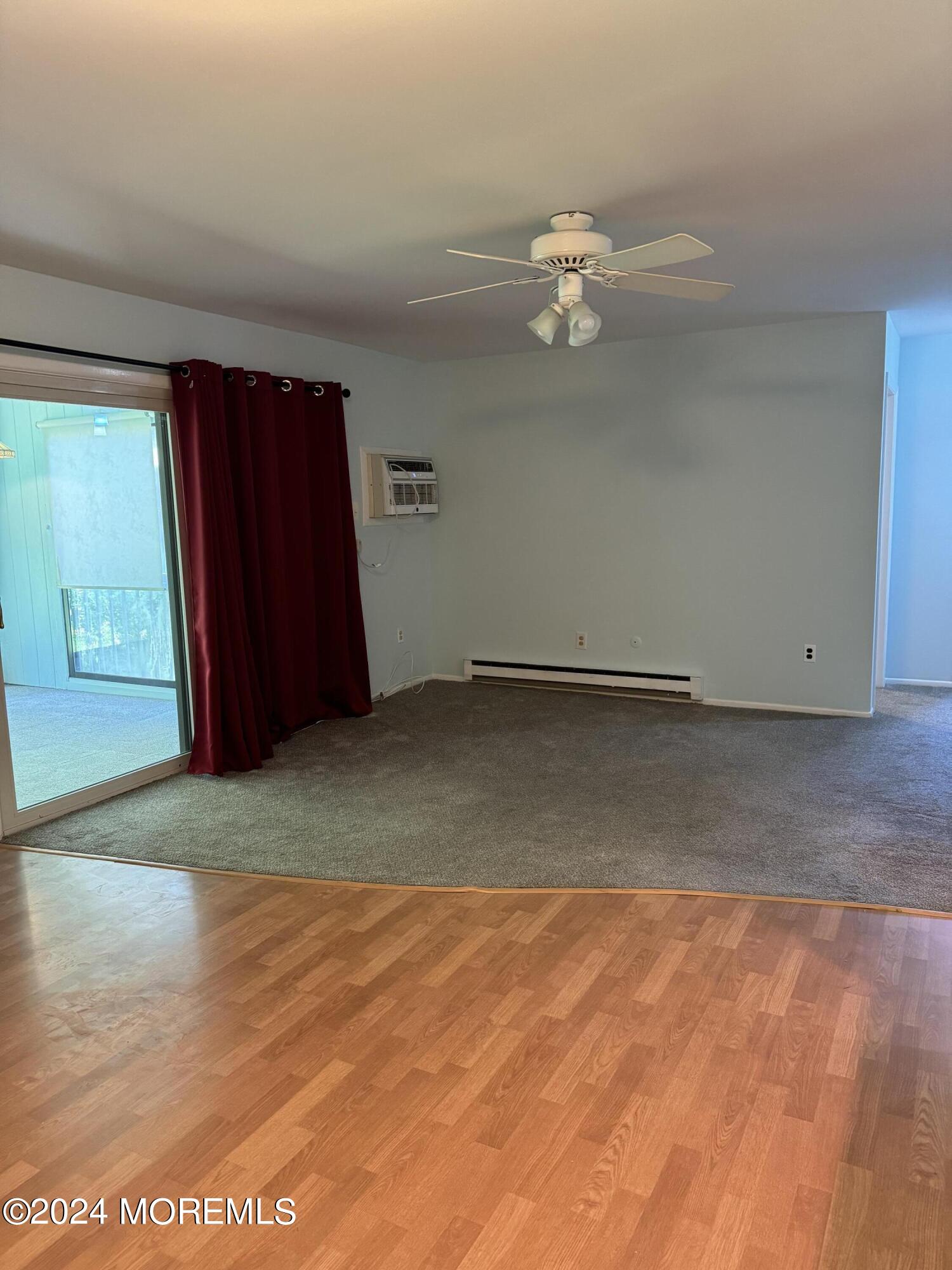95 Lexington Court Red Bank, NJ 07701 - Photo 2 of 26 an empty room with wooden floor and windows