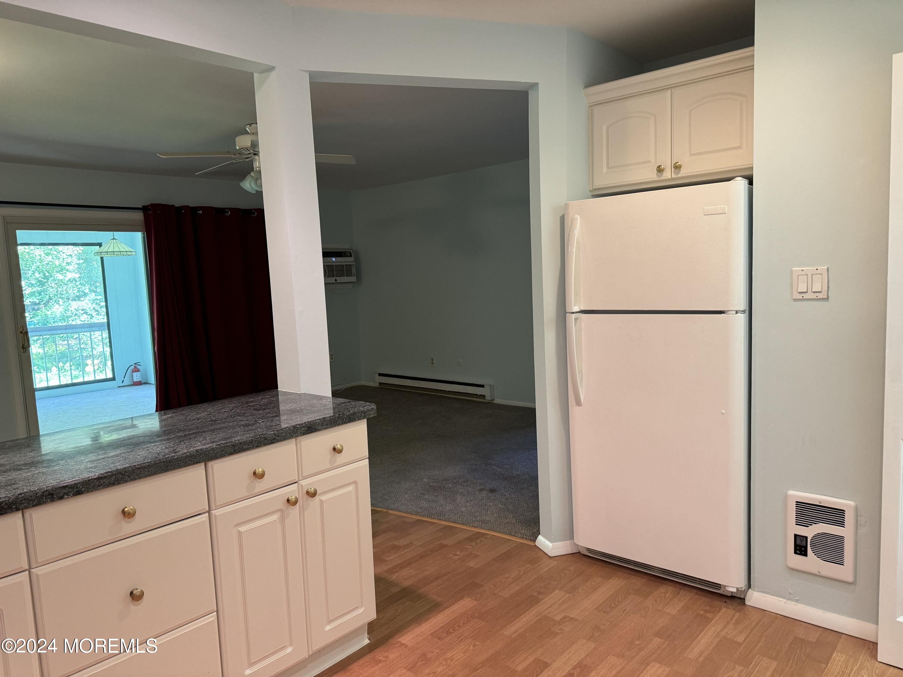 95 Lexington Court Red Bank, NJ 07701 - Photo 23 of 26 a kitchen with granite countertop white cabinets and refrigerator