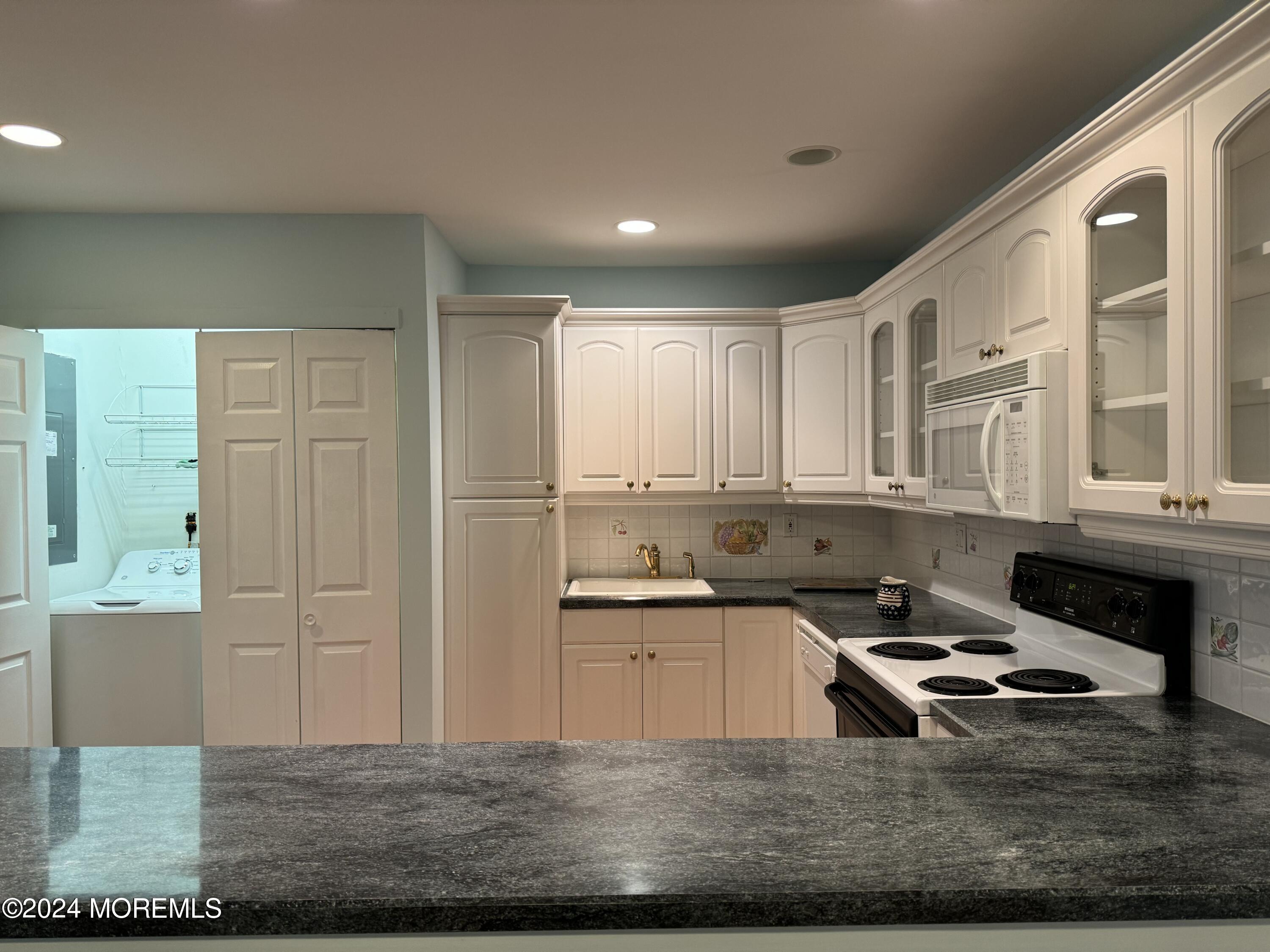 95 Lexington Court Red Bank, NJ 07701 - Photo 3 of 26 a kitchen with granite countertop a sink and a stove