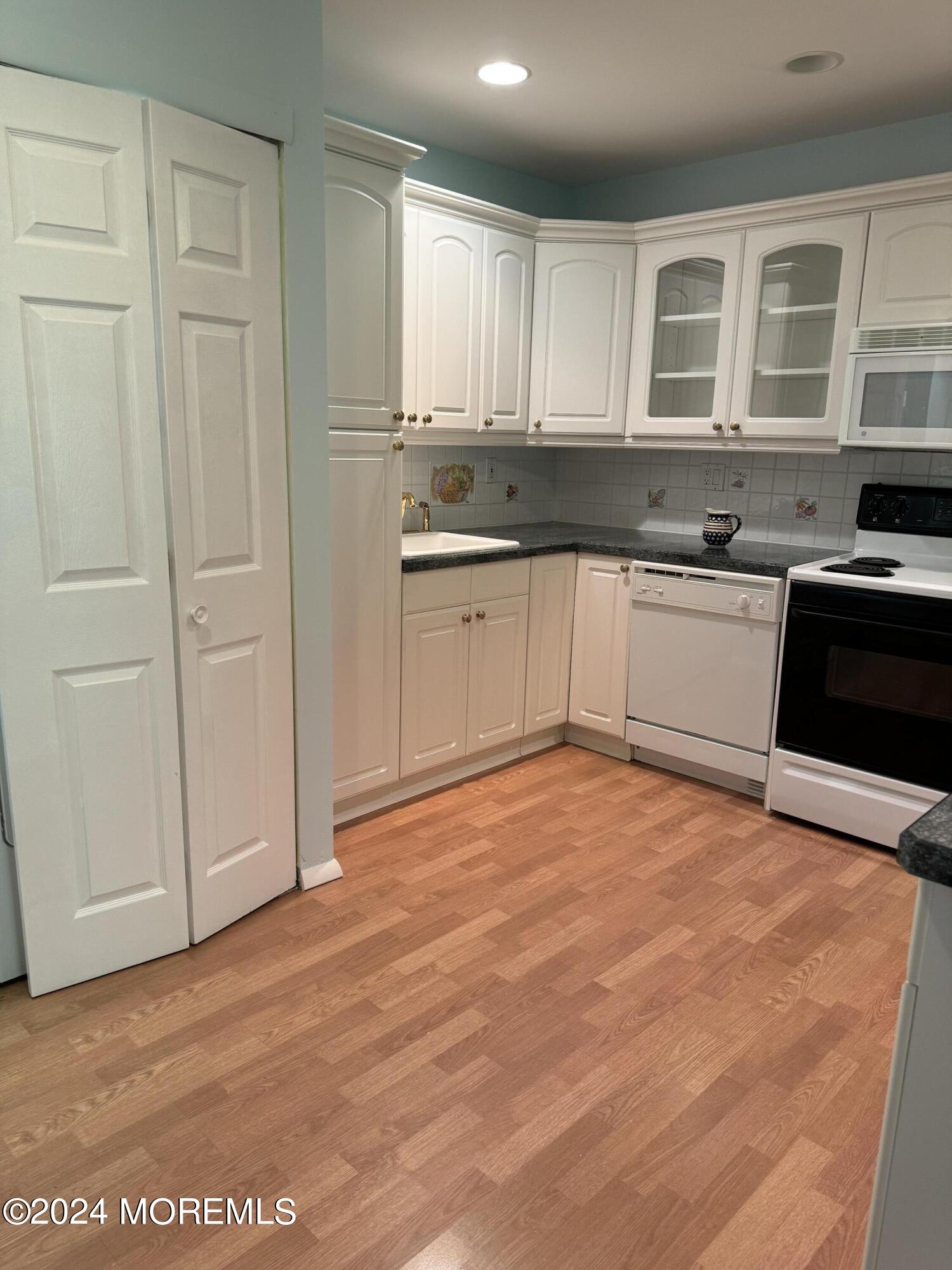 95 Lexington Court Red Bank, NJ 07701 - Photo 5 of 26 a kitchen with granite countertop a stove a sink and a granite counter tops