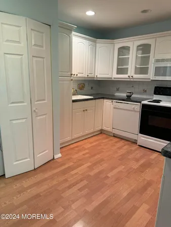 a kitchen with granite countertop a stove a sink and a granite counter tops