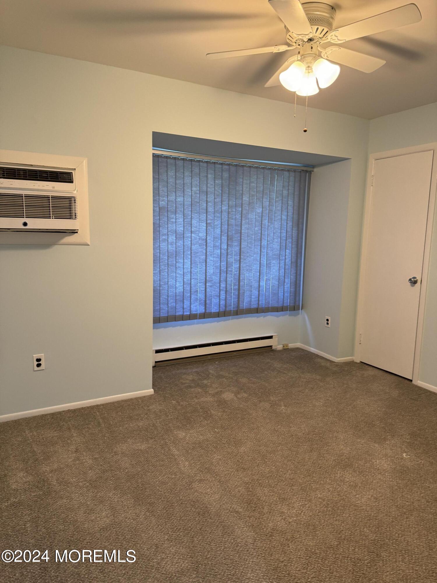 95 Lexington Court Red Bank, NJ 07701 - Photo 10 of 26 an empty room with a ceiling fan and wooden floor