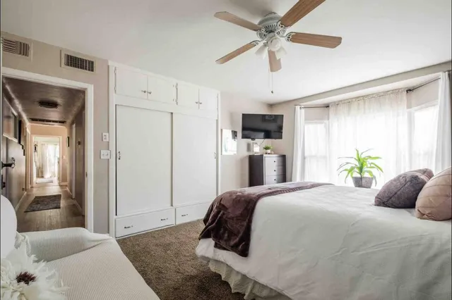 a bedroom with a bed dresser and a window