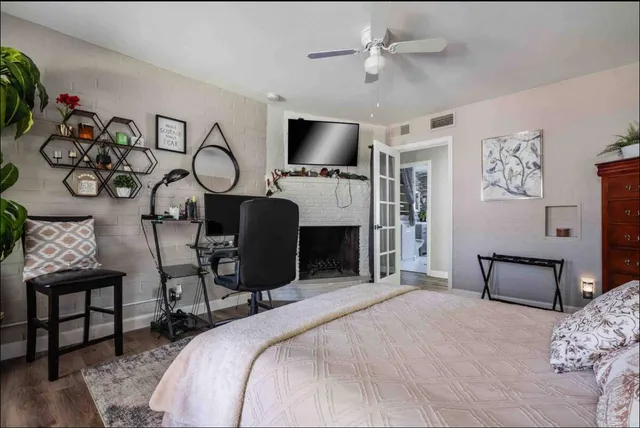 a bedroom with furniture and a flat screen tv