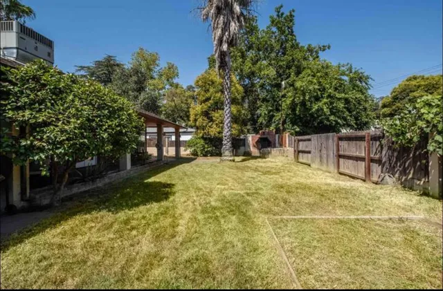 a view of a house with backyard and porch