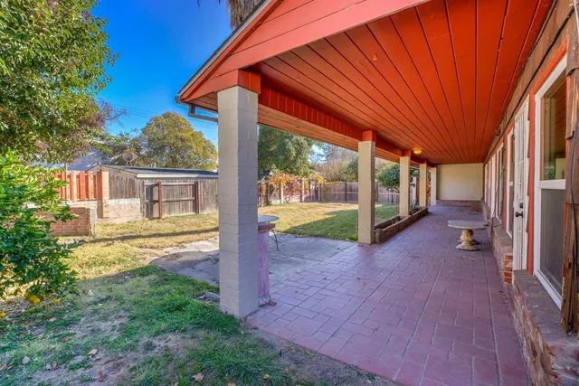 a view of a house with a yard patio and swimming pool
