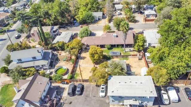 an aerial view of residential house with swimming pool and outdoor seating