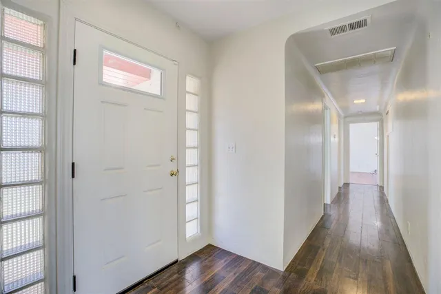 a view of a hallway with wooden floor