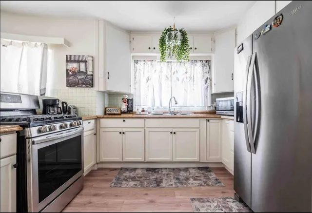a kitchen with a stove a refrigerator and a sink