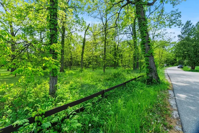 an aerial view of a houses with a lake view