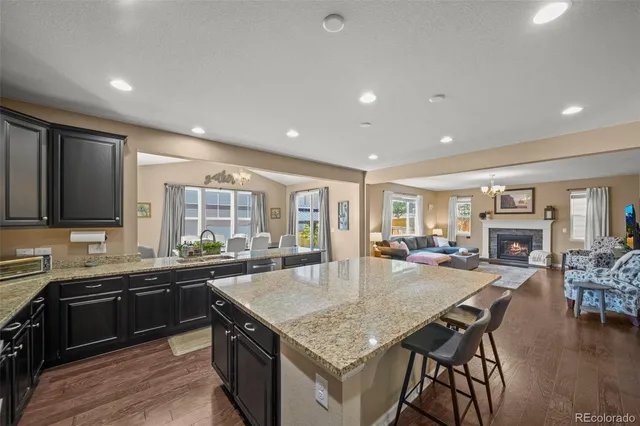 a kitchen with sink table and chairs