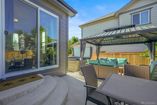 a view of a patio with a table and chairs