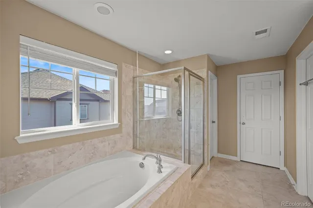 a bathroom with a bathtub and a shower