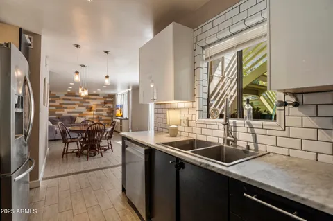 a kitchen with a sink and a refrigerator