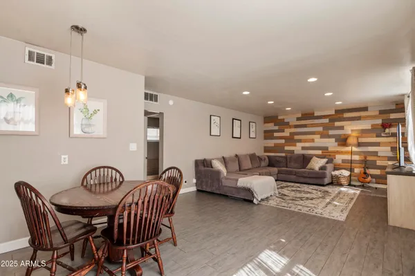 a living room with furniture and a wooden floor