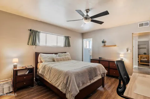 a bedroom with a bed and wooden floor