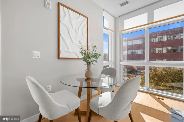 a dining room with furniture and wooden floor