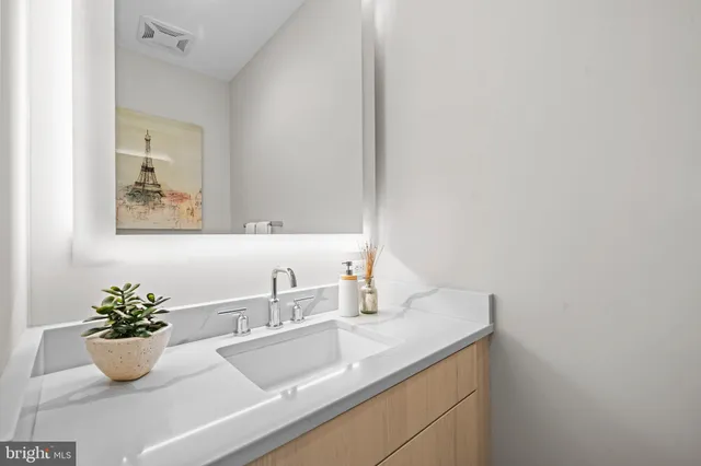 a bathroom with a sink and mirror
