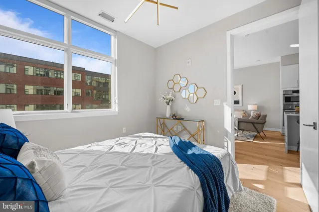 a bedroom with a bed and a large window