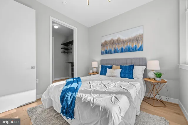 a bedroom with a bed and painting on the wall