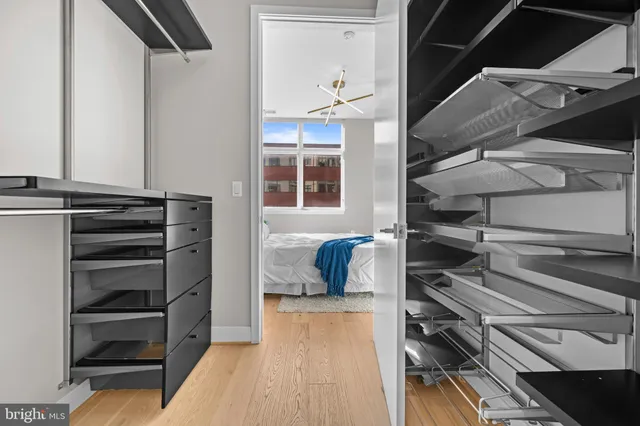 a bathroom with a granite countertop sink a toilet a mirror a bathtub and shower