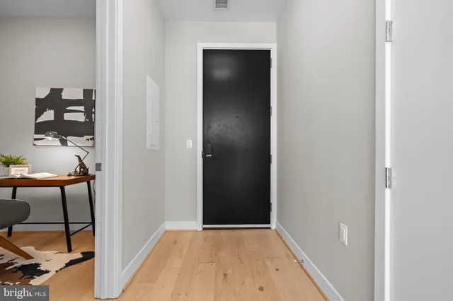 an empty room with wooden floor and closet