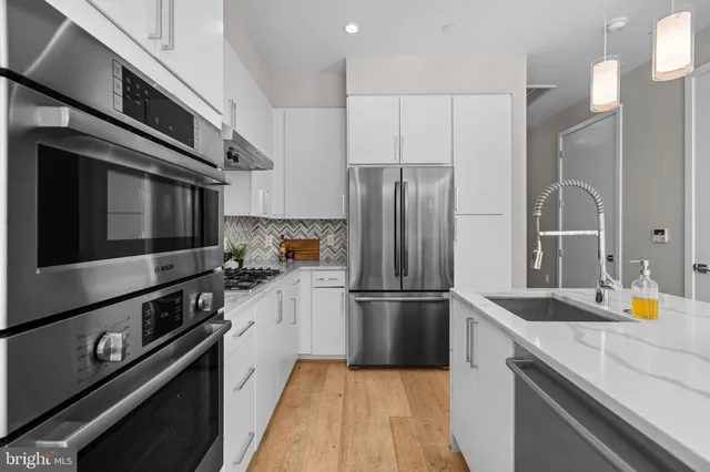 a kitchen with a refrigerator and a sink