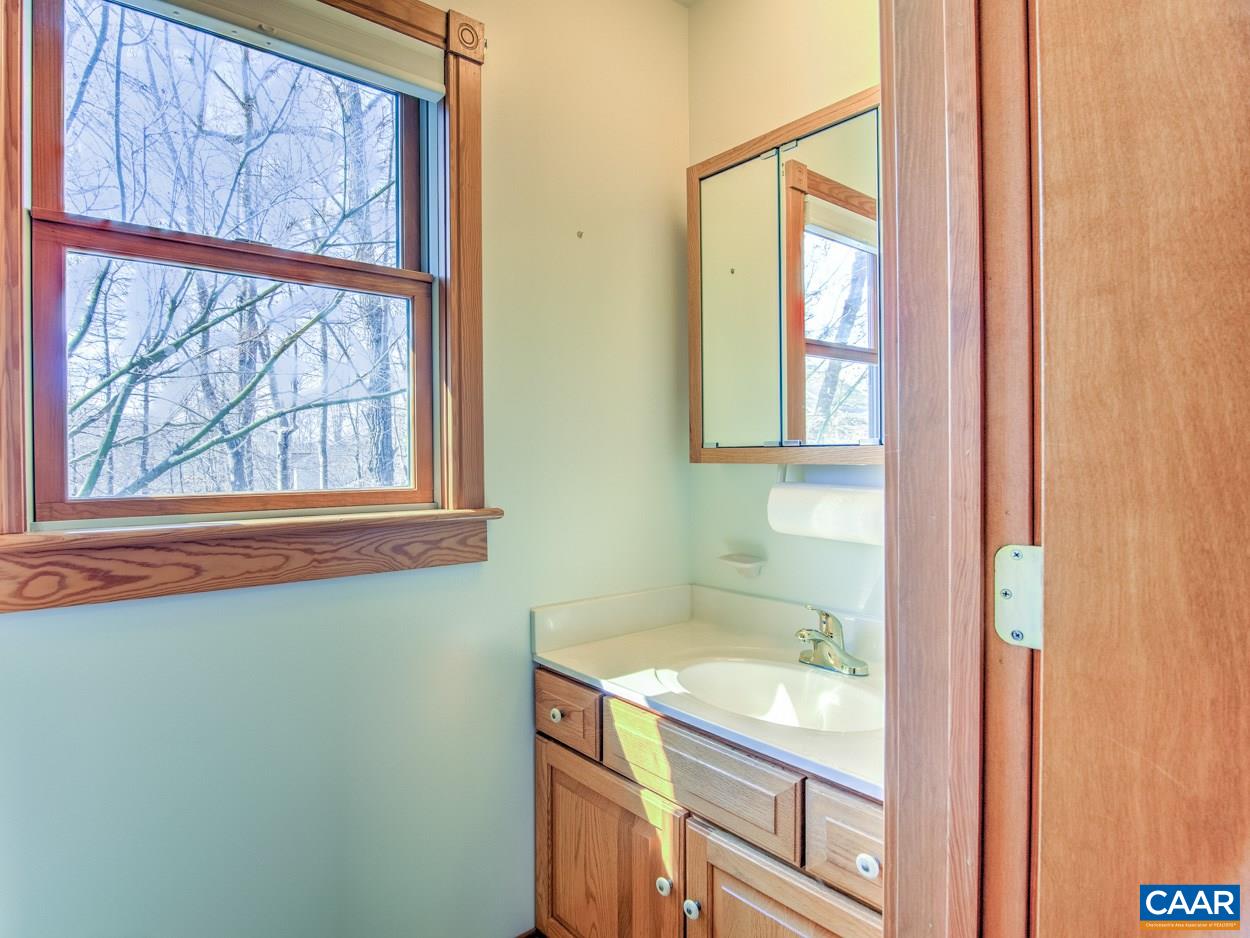 87 Laguna Road Palmyra, VA 22963 - Photo 27 of 38 a bathroom with a granite countertop sink and a window