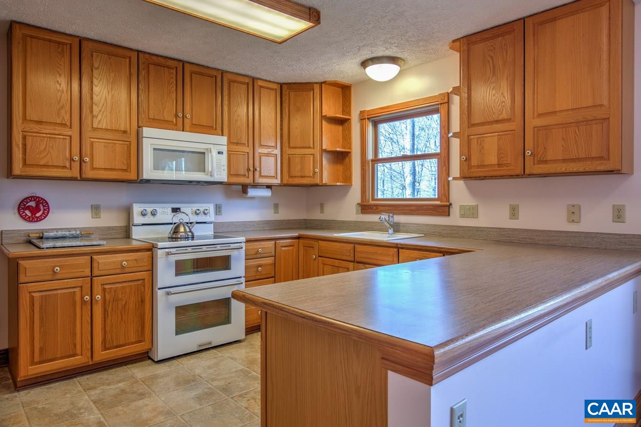87 Laguna Road Palmyra, VA 22963 - Photo 3 of 38 a kitchen with stainless steel appliances granite countertop a sink a stove and cabinets