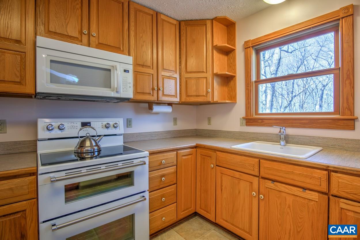 87 Laguna Road Palmyra, VA 22963 - Photo 6 of 38 a kitchen with stainless steel appliances granite countertop white cabinets and a stove top oven