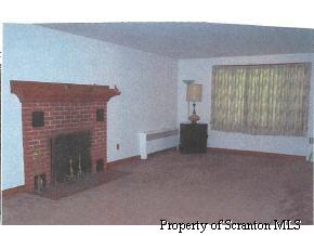 110 Market Street Moscow, PA 18444 - Photo 2 of 5 a view of an empty room with a fireplace